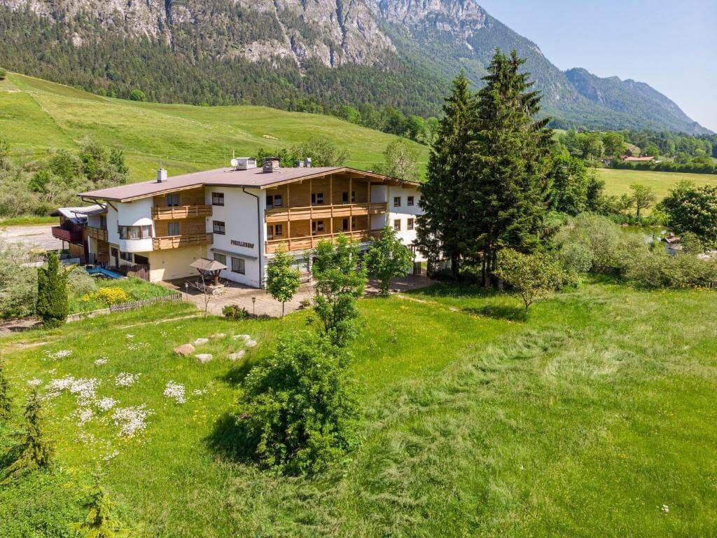 A wooden chalet below the Alps.